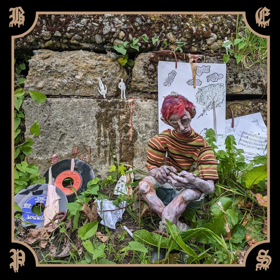 The cover for Black Ends' album "Psychotic Spew". It features a mannequin or puppet boy in front of a stone wall.