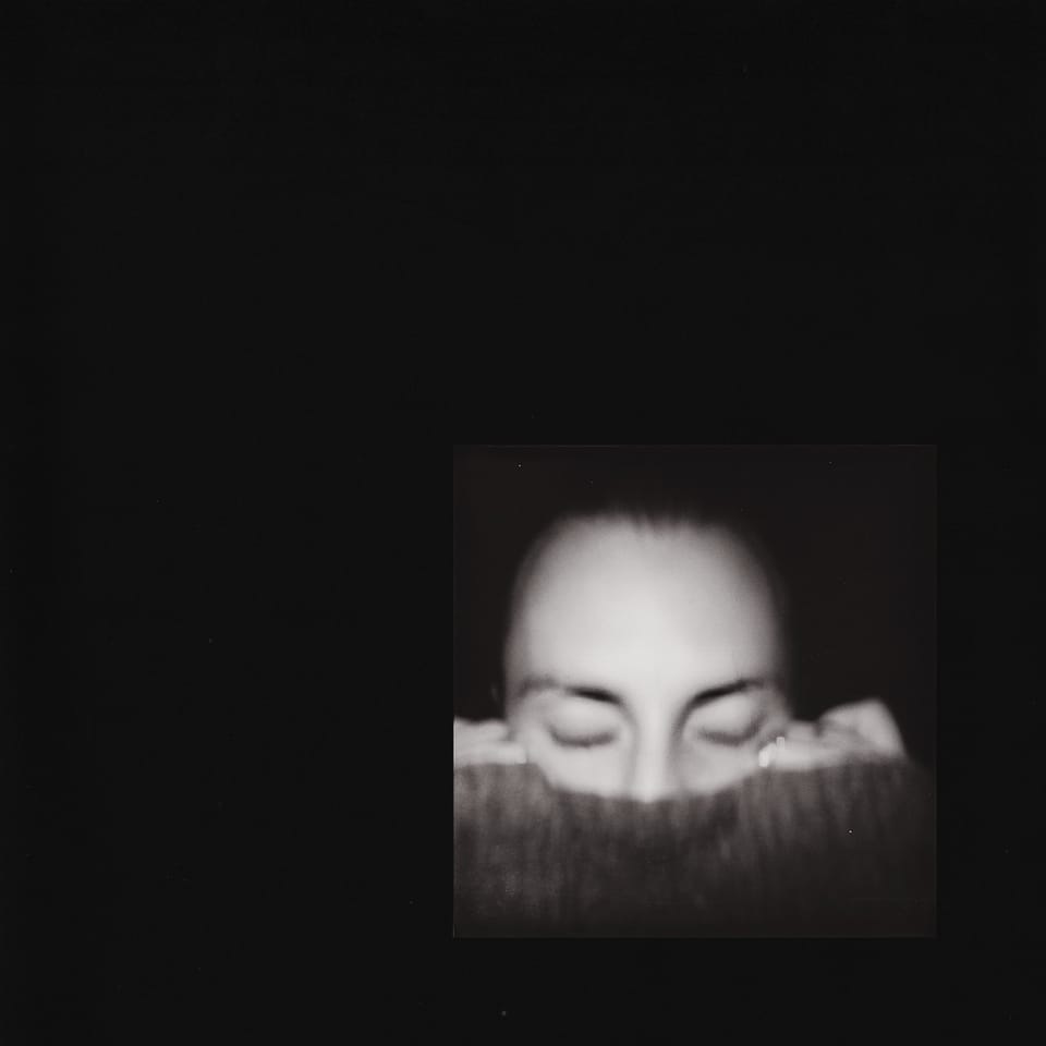 Cover of "antichamber." Black background with a photo of Jacob Allen covering his mouth with his sweater in the lower right.