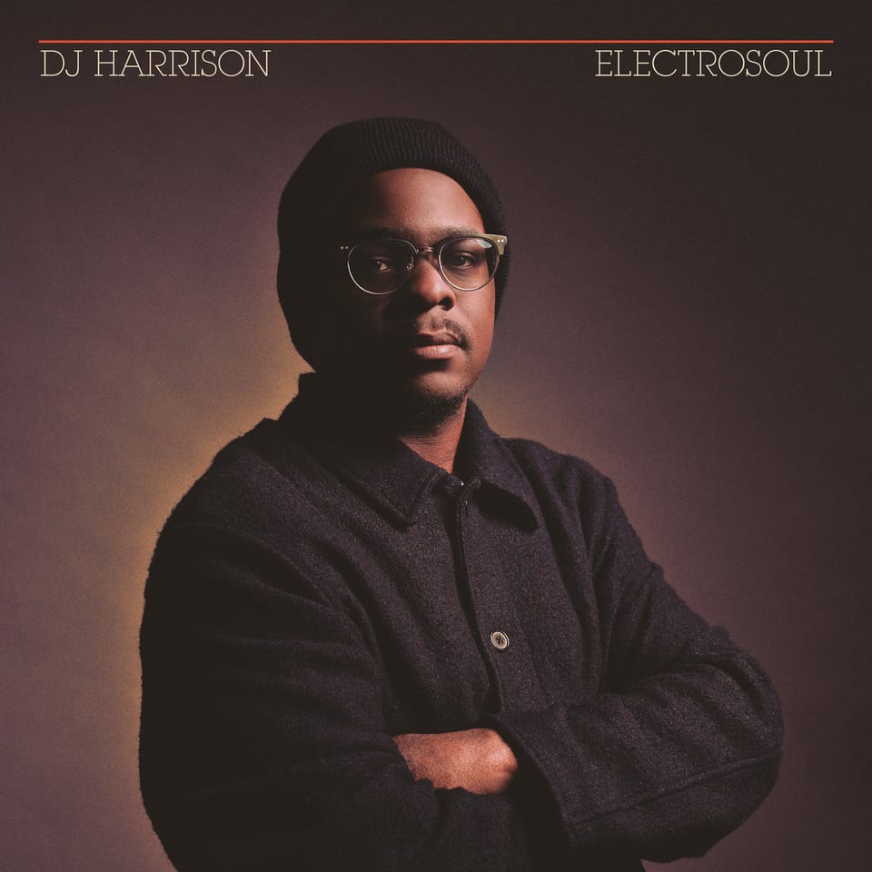 The cover of DJ Harrison's "ElectroSoul", features DJ Harrison with his arms crossed, wearing a wool coat and black beanie.